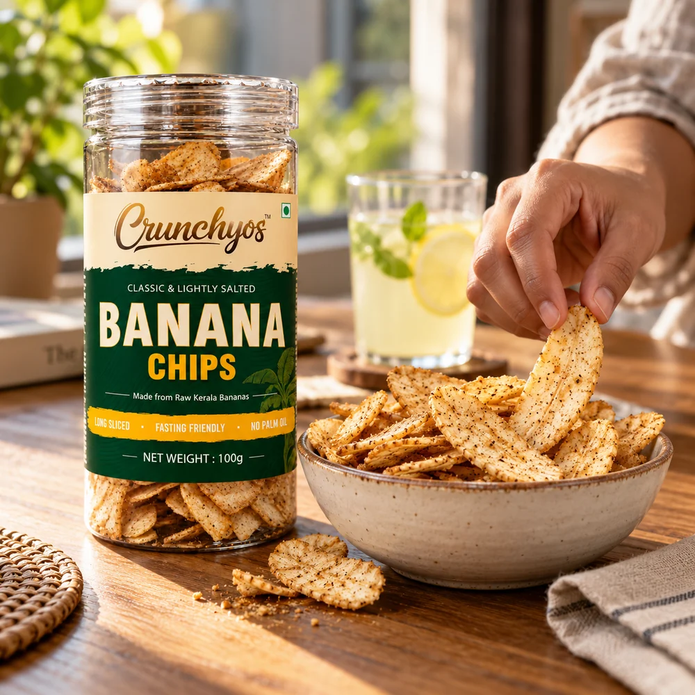 A jar of Crunchyos Banana Chips beside a bowl of chips and a glass of lemonade
